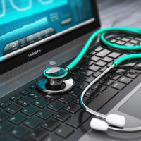 Telehealth Emerging As A New Field Of Healthcare Fraud - Laptop with medical diagnostic software and stethoscope