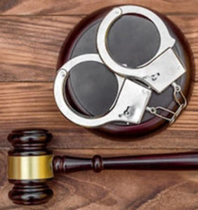 Gavel with handcuffs as person is Receiving a Bail Amount