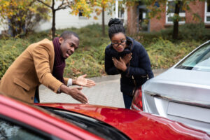 Man and woman arguing over a fender bender before calling a Car Accident Lawyer Houston, TX