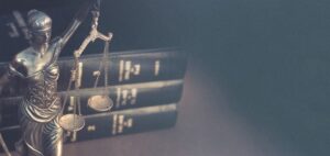 Law books and lady justice statue on the desk of a Wrongful Death Lawyer Houston, TX