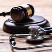 Medical Malpractice Information - Gavel And Stethoscope On Table